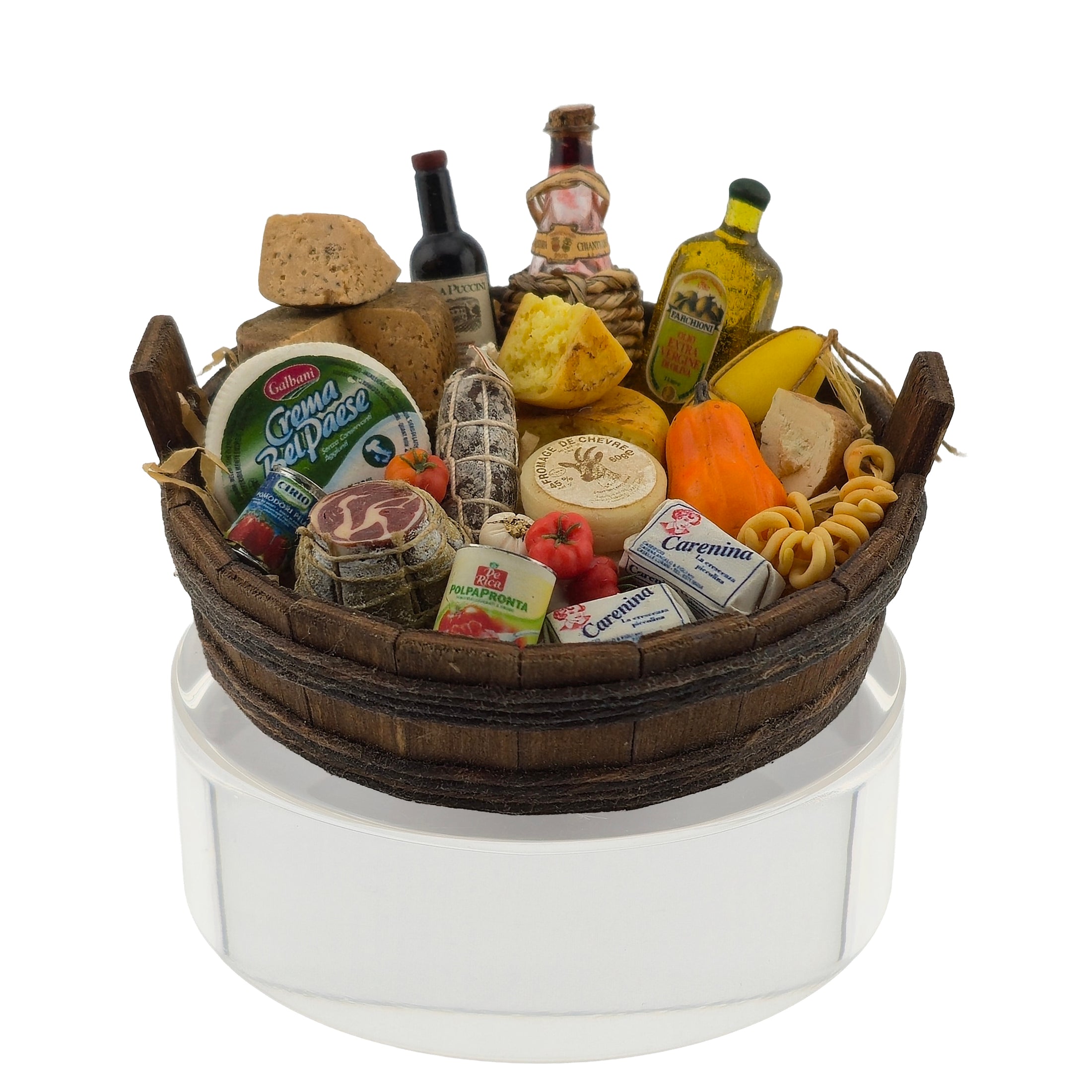 Gourmet food basket with various items including meats, cheeses, and fruits on a white background