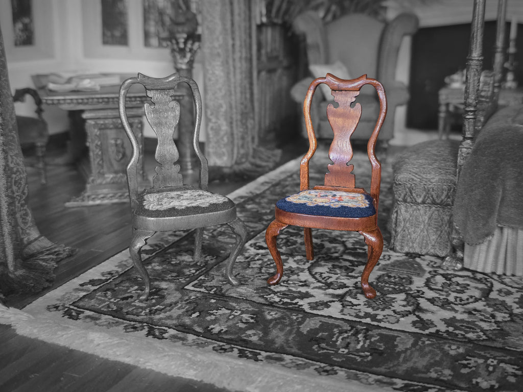 Two wooden chairs with embroidered seats on a patterned rug in a room with furniture and decor.