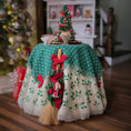 Load image into Gallery viewer, Decorative table with a green and white cloth, Christmas tree, and broom in a festive setting.
