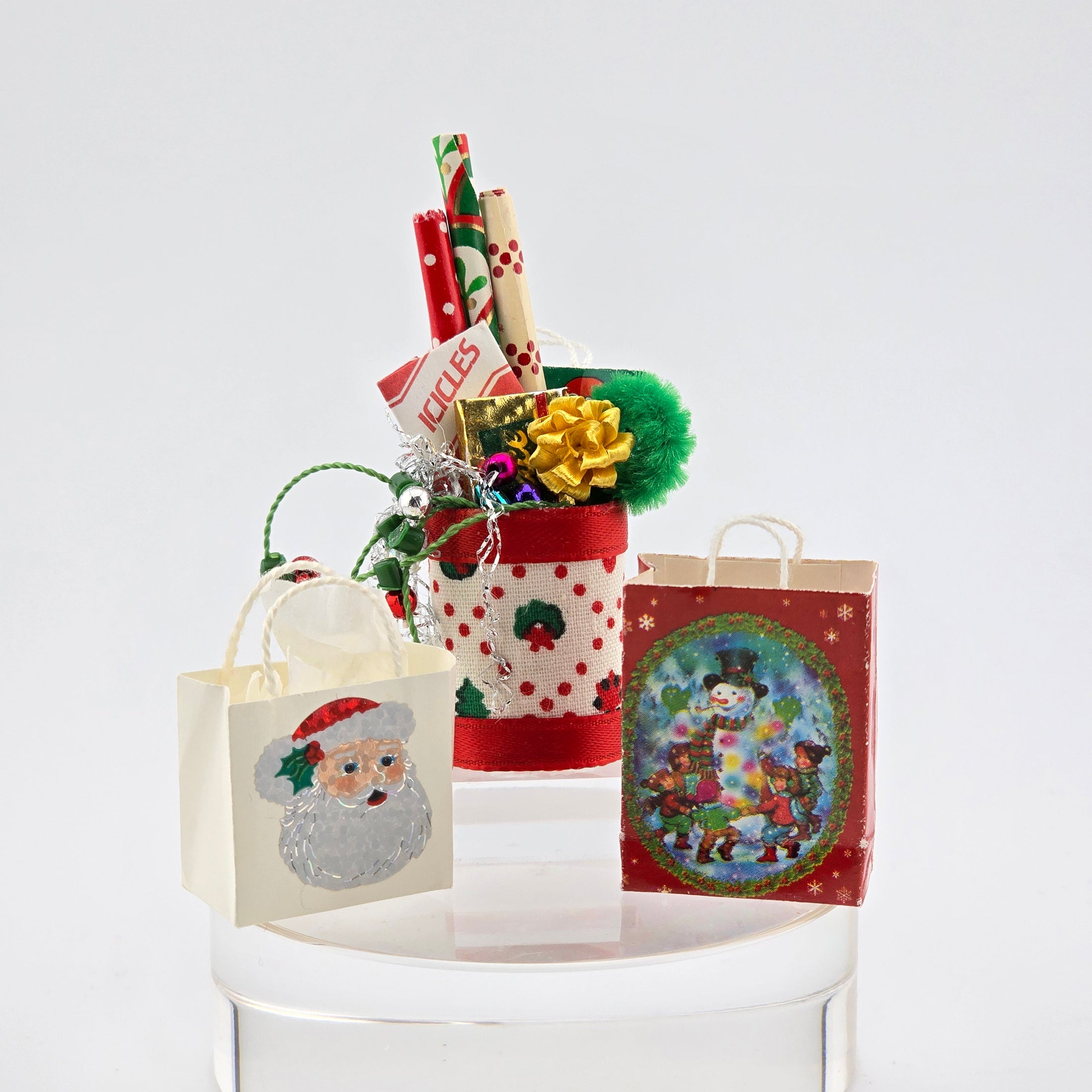 Christmas-themed gift bag with Santa Claus design on a white surface
