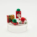 Set of Christmas-themed gift boxes with decorative bows on a white base.