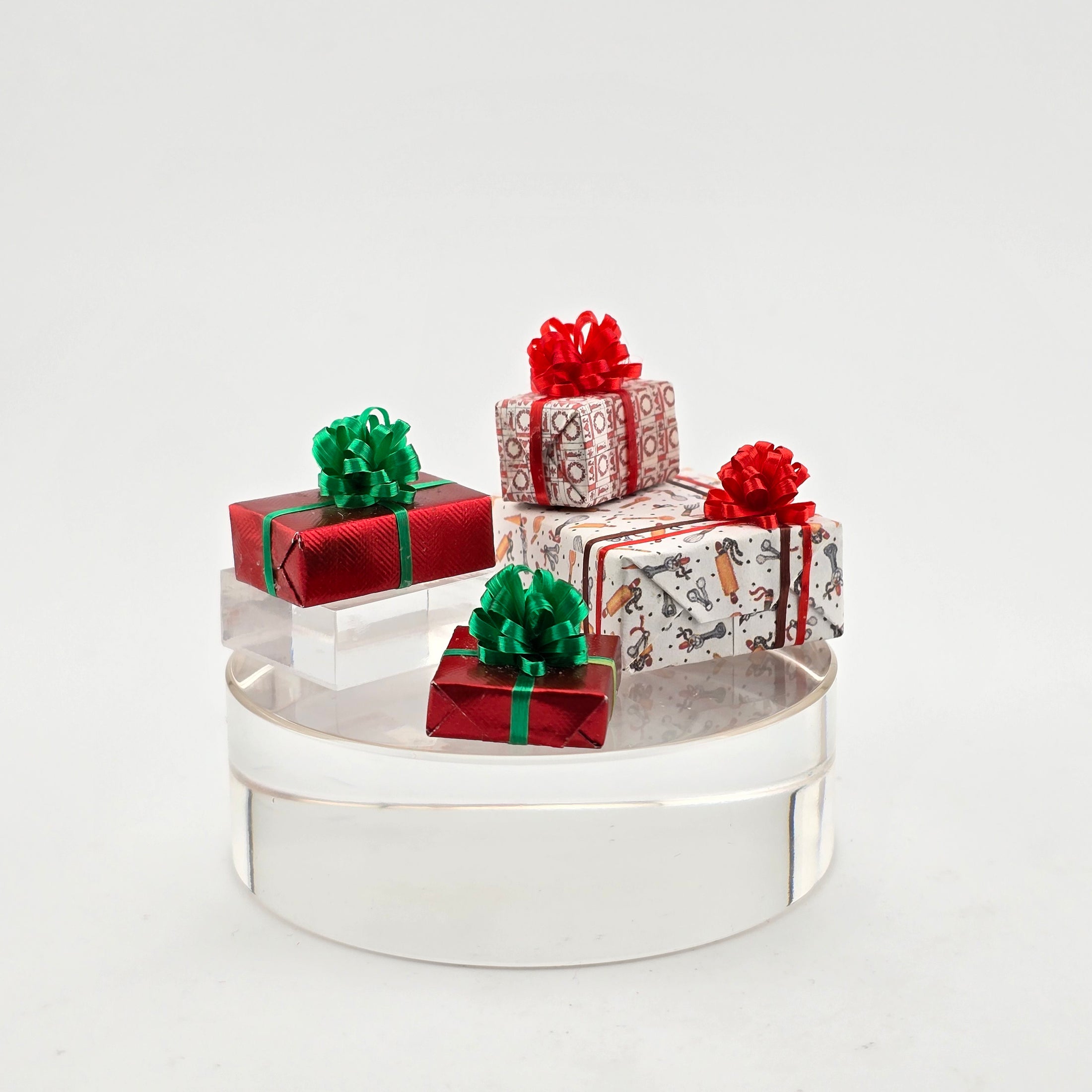 four miniature christmas gifts on a white background