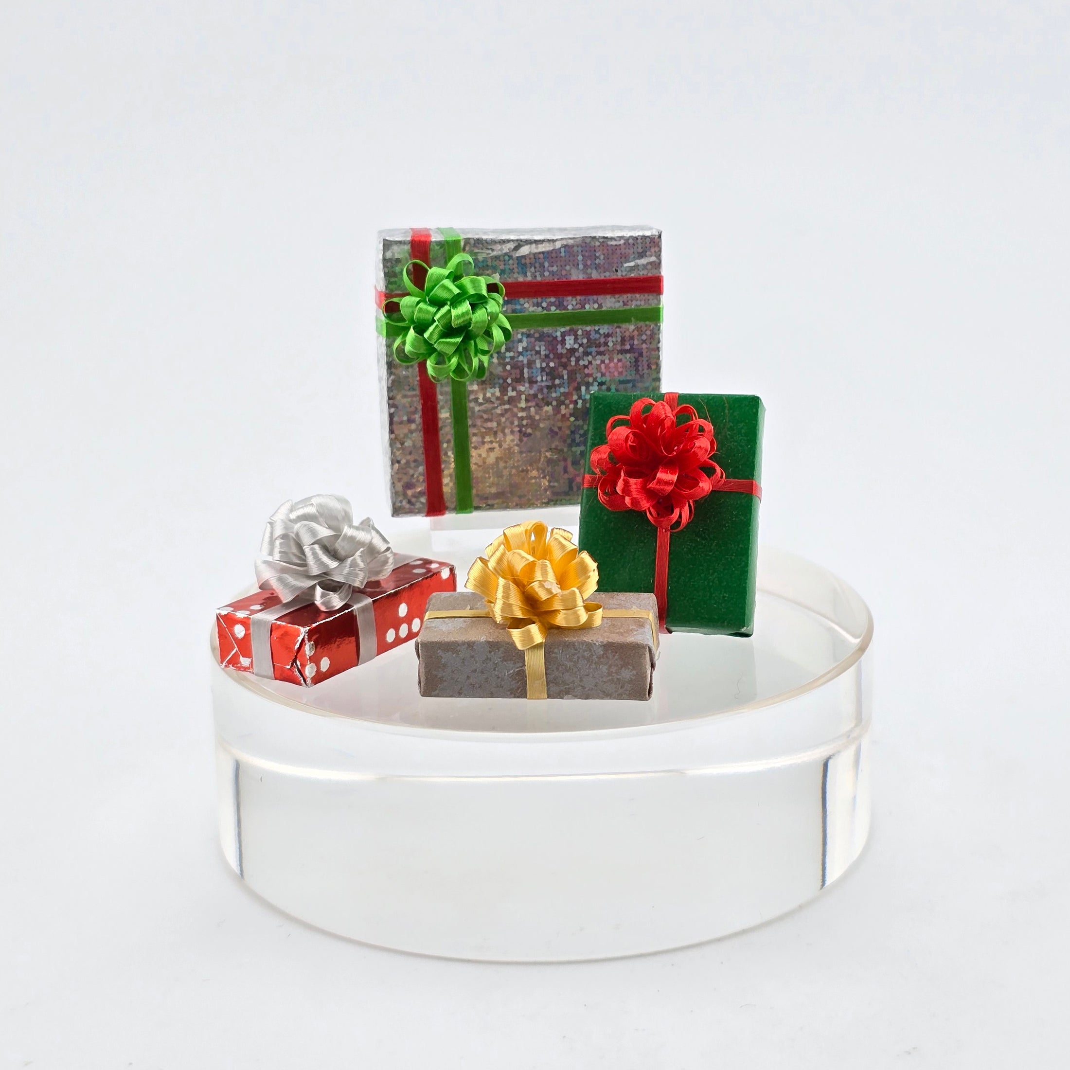group of four miniature dollhouse christmas presents, hand wrapped