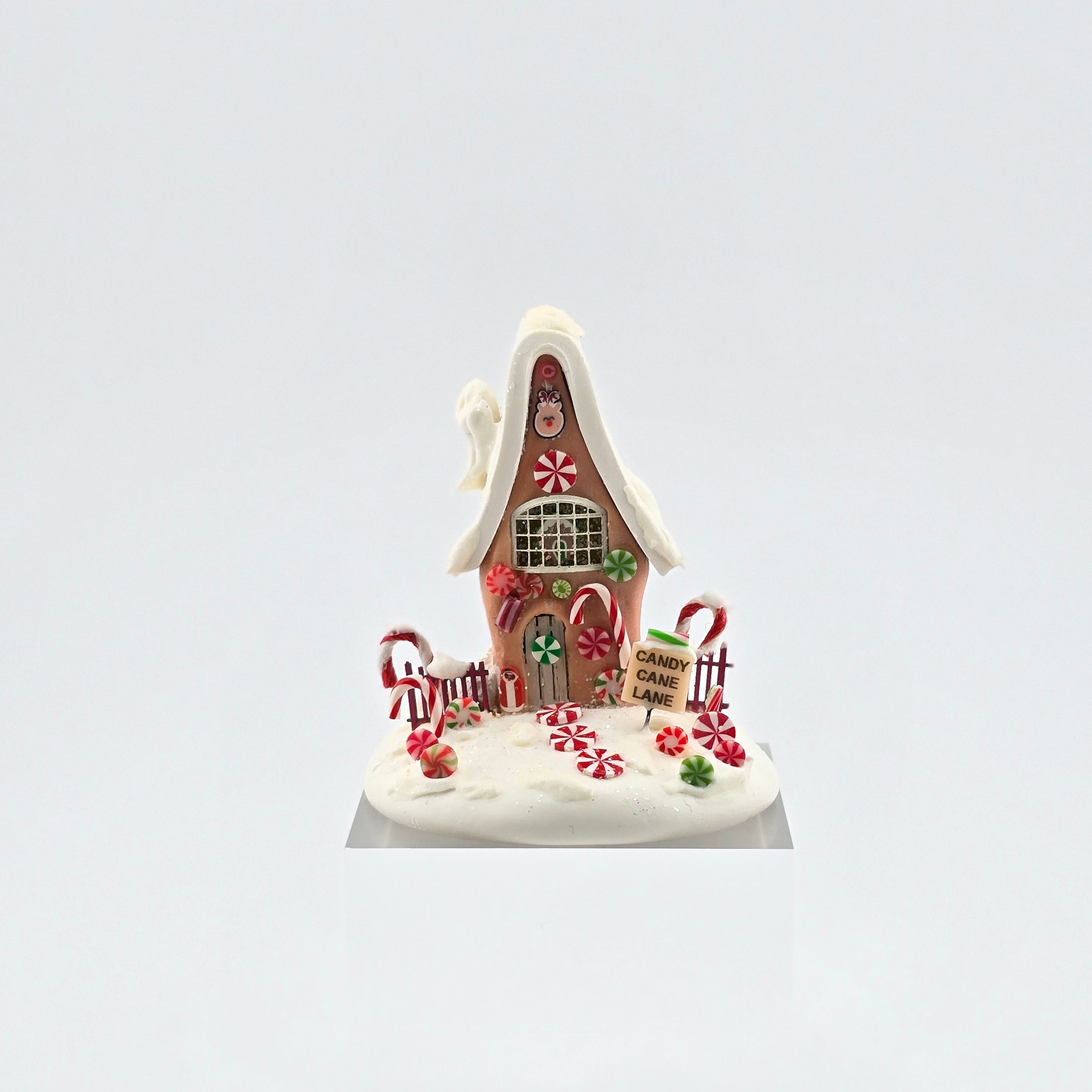 Candy cane gingerbread house on white background