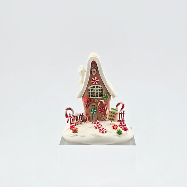 Candy cane gingerbread house on white background