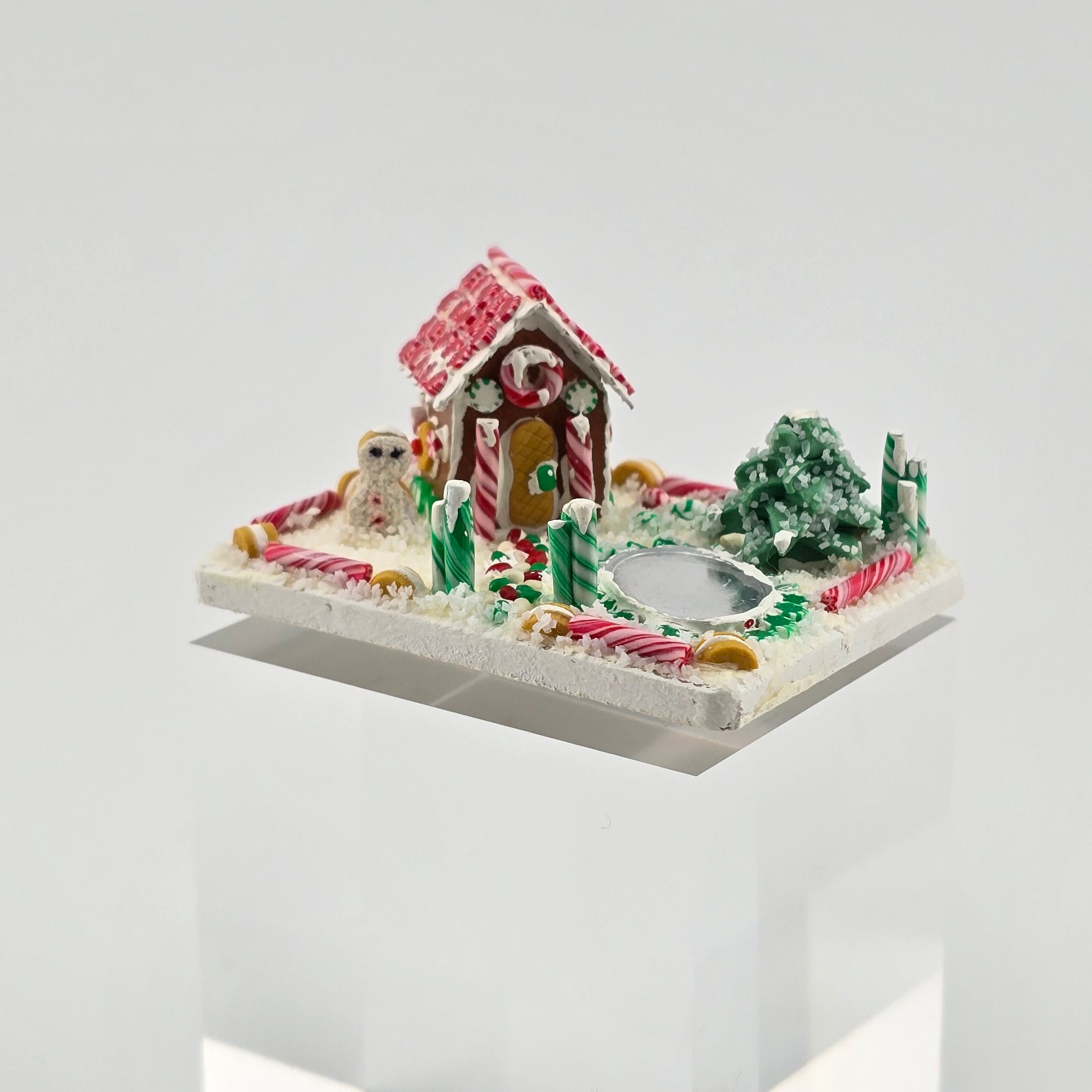 Gingerbread house with candy decorations on a white background