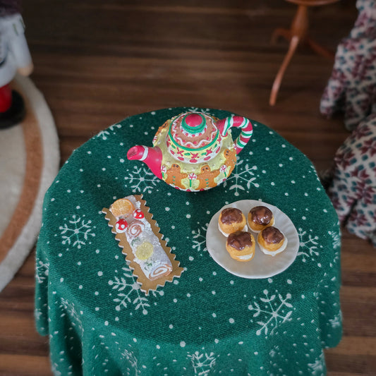 tea pot, eclairs and yule log, top view
