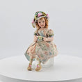 Load and play video in Gallery viewer, Seated Porcelain Little Girl Doll with Teacup, Green Silk Hat & Leather Shoes
