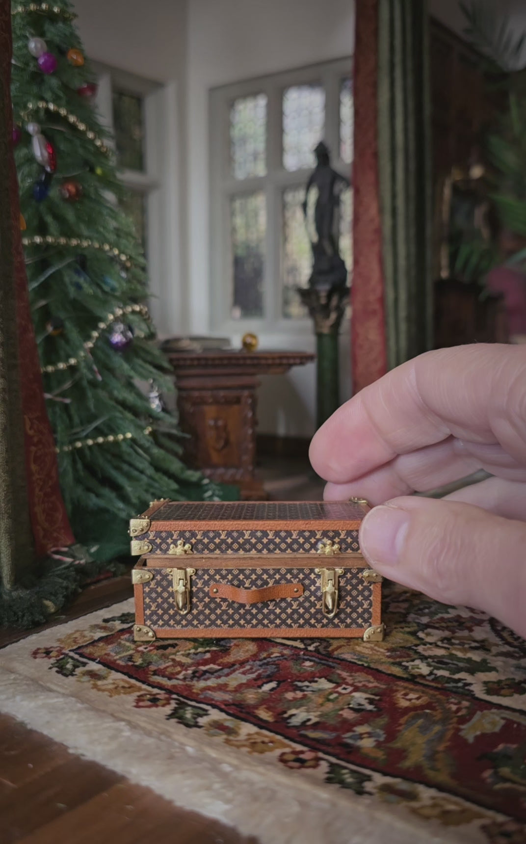 video of a miniature trunk being opened to reveal glass ornaments inside