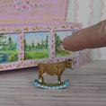 Load and play video in Gallery viewer, Barbara Cooper Painted Metal Primitive Rocking Cow Toy for Nursery
