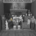 Load image into Gallery viewer, Vintage dollhouse with detailed furniture and figures in a room setting.
