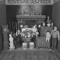 Load image into Gallery viewer, Black and white miniature dollhouse scene with furniture and figures.
