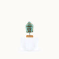 Miniature Turquoise Buddha head sculpture on a white background