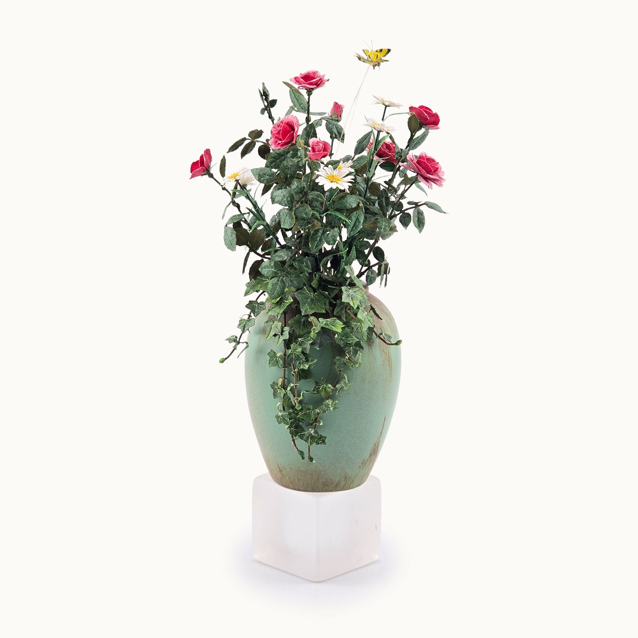 Decorative vase with artificial flowers on a white background by Jeannie Lindquist
