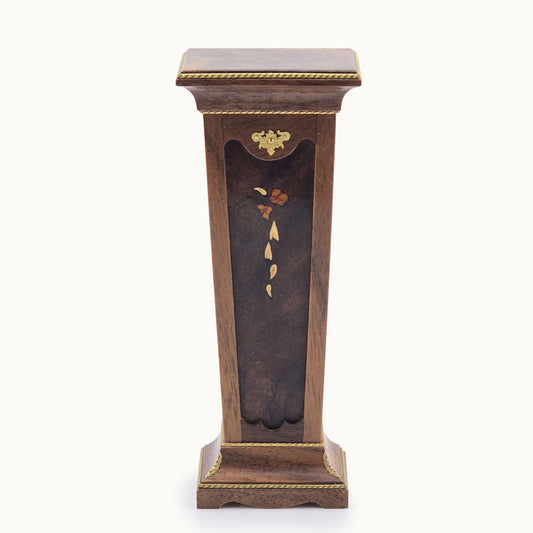 Wooden pedestal with decorative elements on a white background