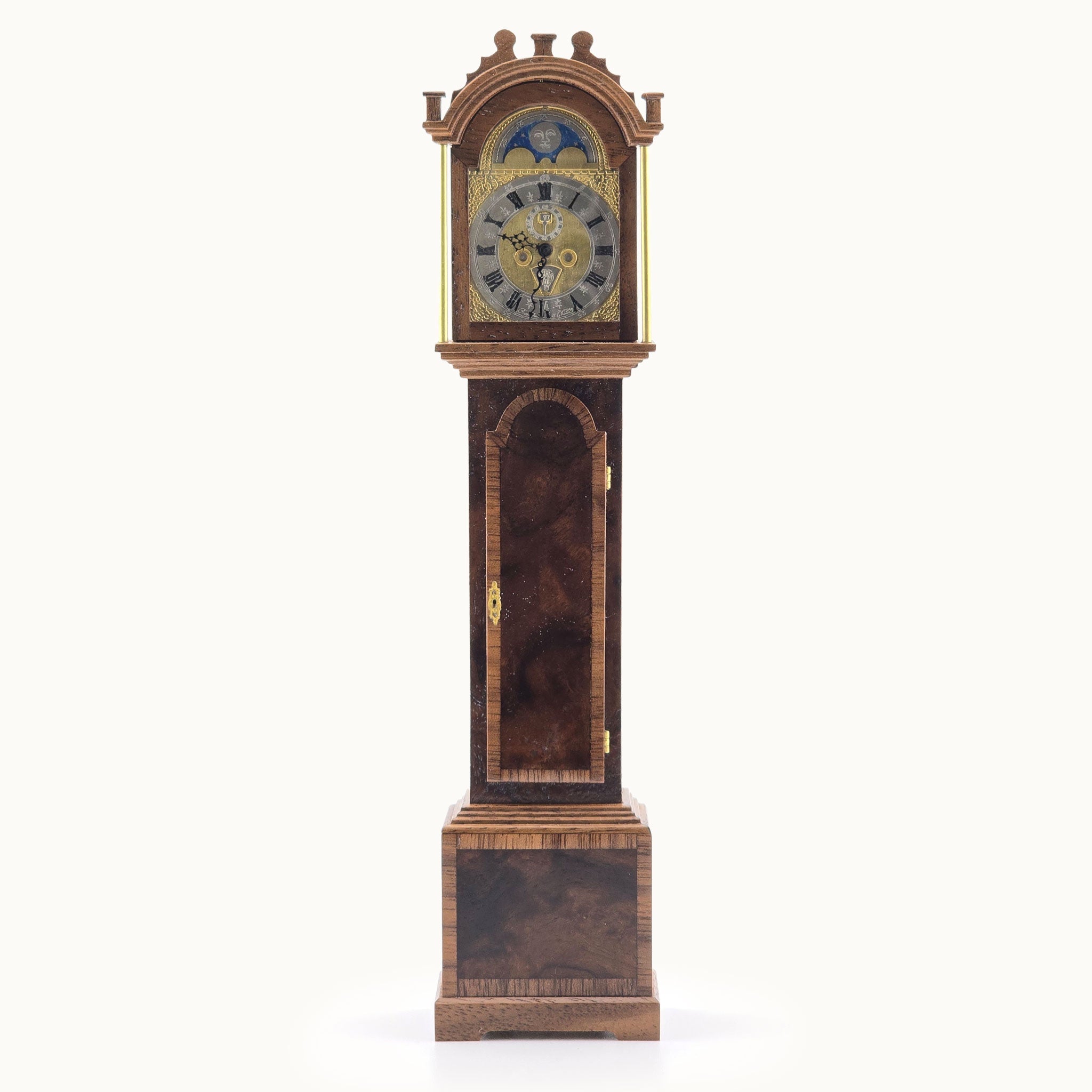 Wooden grandfather clock with detailed face on a white background