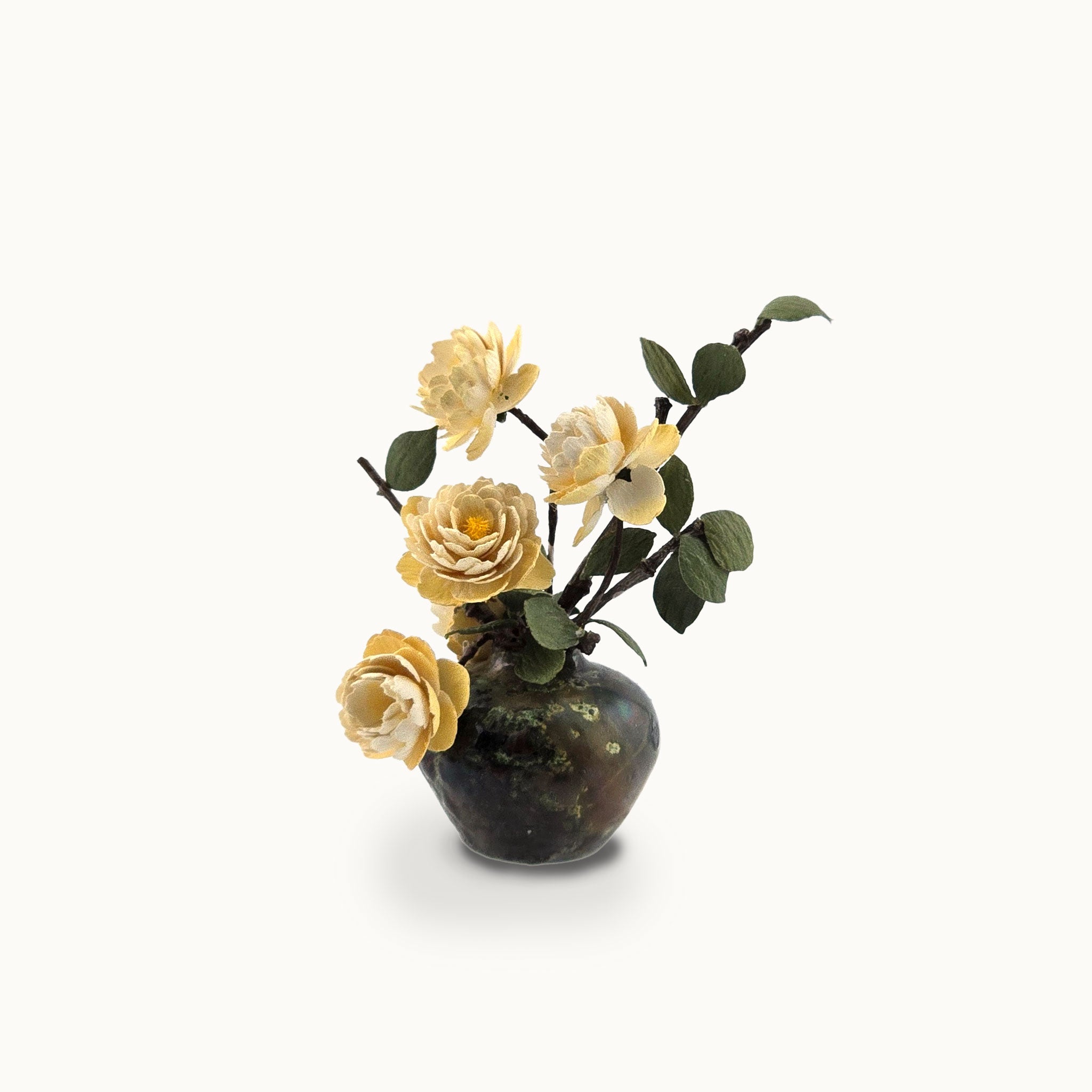 Small vase with yellow flowers on a white background