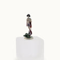 Load image into Gallery viewer, Porcelain figurine of a traditional Japanese geisha on a white pedestal with a white background
