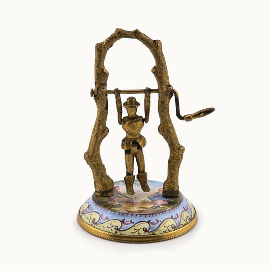 Decorative miniature dollhouse children's toy with a person on a swing on a white background