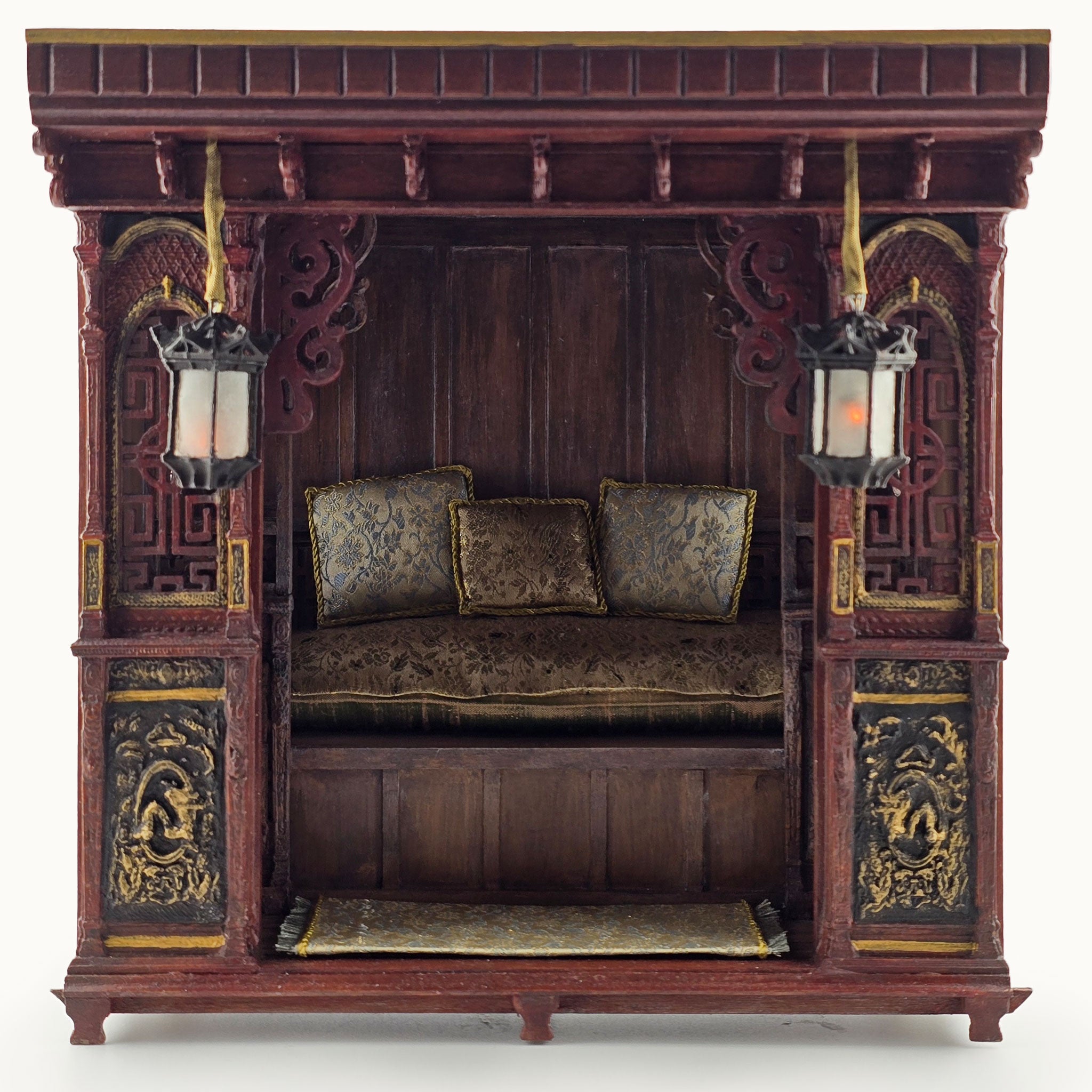 Decorative wooden canopy bed with intricate carvings and lanterns on a white background