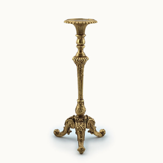 Decorative gold candlestand on a white background by John J. Hodgson