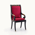 Decorative armchair with red cushion and black frame on a white background