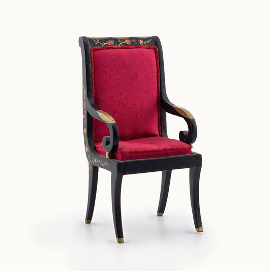 Decorative armchair with red cushion and black frame on a white background