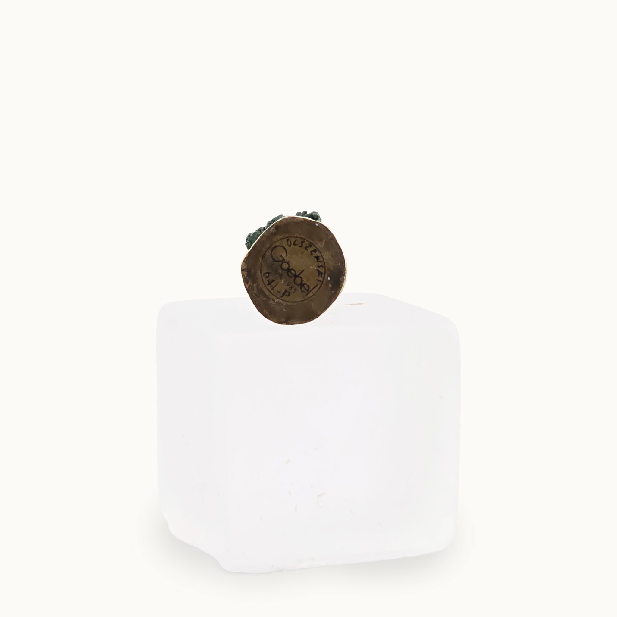 Bronze signed underside of statue on a white background